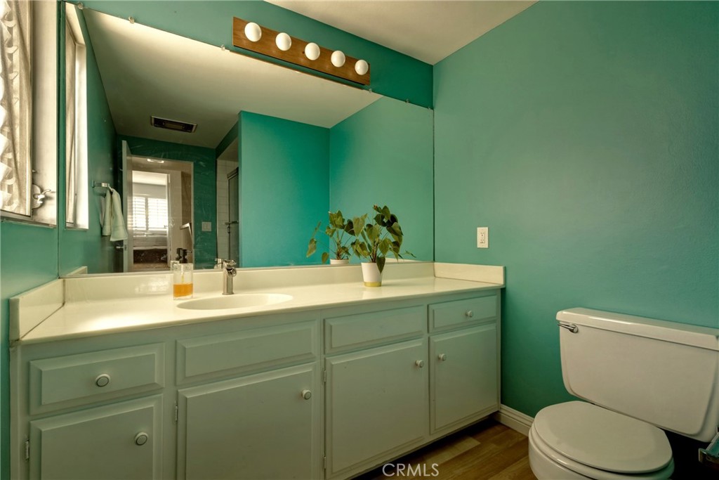 4331 West Sarah Street, Unit 10 Burbank, CA 91505 - Photo 14 of 26 a bathroom with a toilet sink and mirror