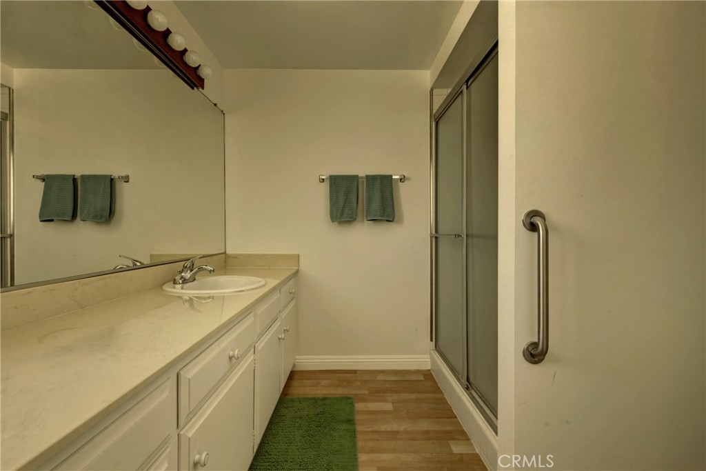 4331 West Sarah Street, Unit 10 Burbank, CA 91505 - Photo 19 of 26 a bathroom with a granite countertop sink and a mirror