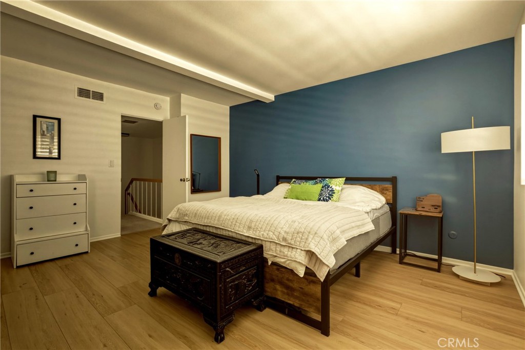4331 West Sarah Street, Unit 10 Burbank, CA 91505 - Photo 20 of 26 a spacious bedroom with a bed and a dresser