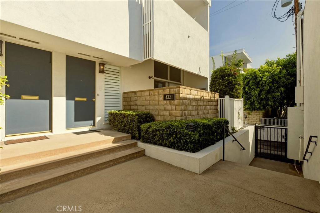 4331 West Sarah Street, Unit 10 Burbank, CA 91505 - Photo 3 of 26 a front view of a house with a yard