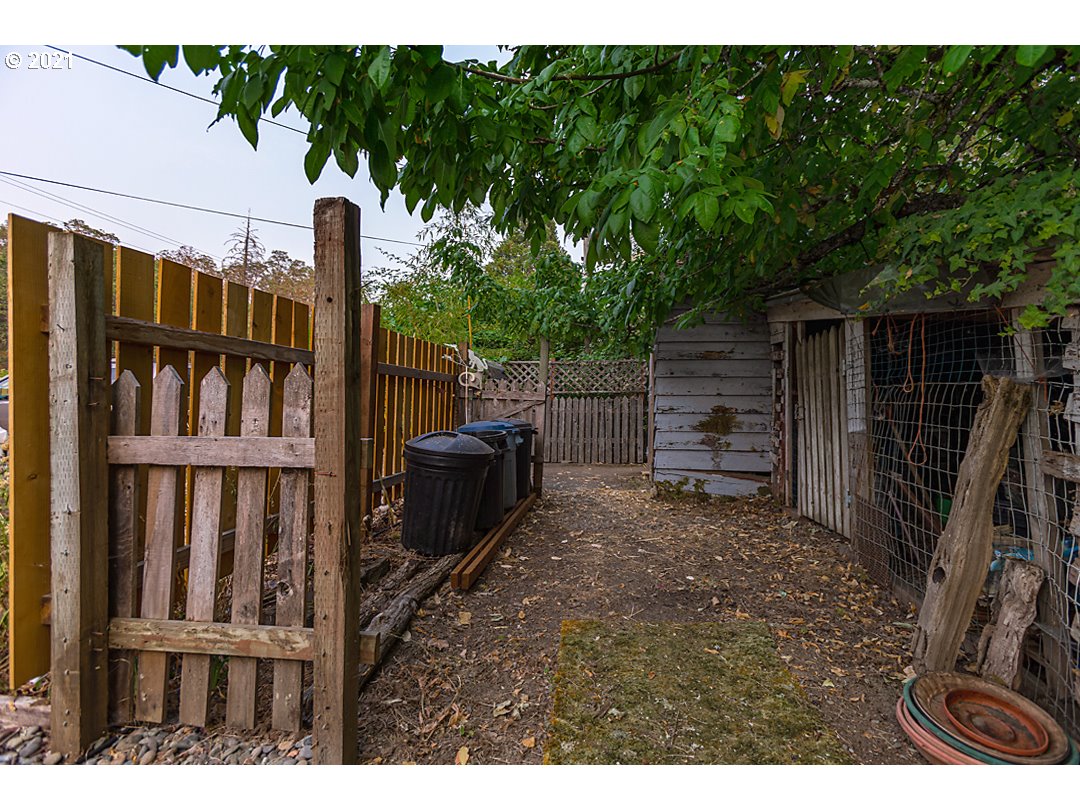 1856 Canyonville-Riddle Road Riddle, OR 97469 - Photo 24 of 27 a backyard of a house with barbeque oven and outdoor seating