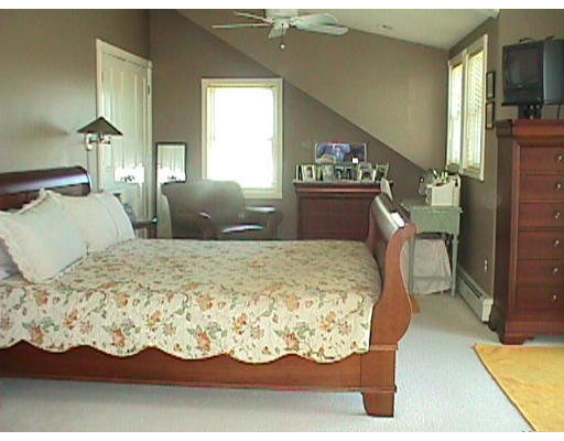 106 Little Neck Road Ipswich, MA 01938 - Photo 9 of 19 a large bed sitting in a bedroom next to a lamp