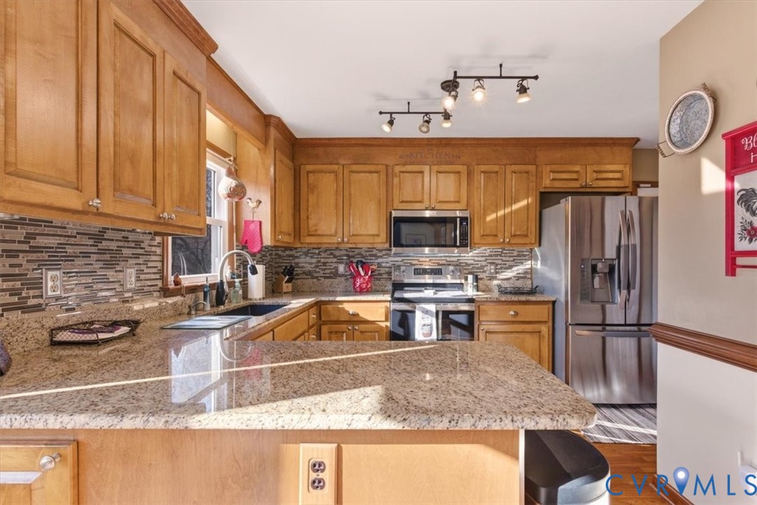 2604 Brookforest Terrace Midlothian, VA 23112 - Photo 13 of 49 a kitchen with stainless steel appliances granite countertop a sink stove and refrigerator