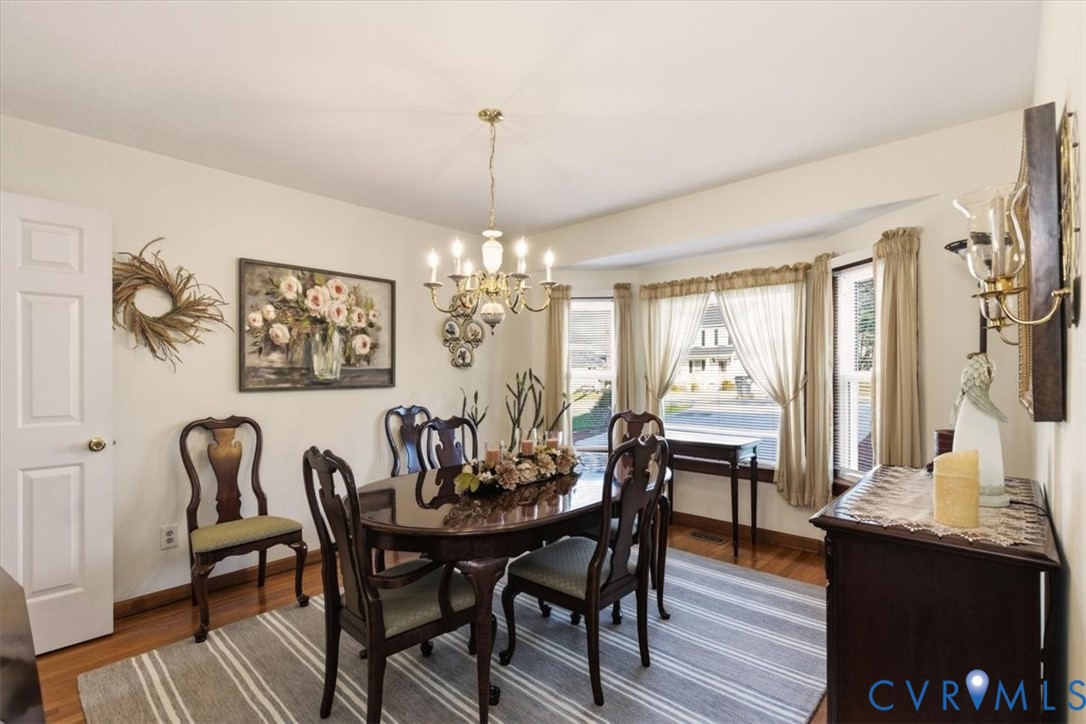 2604 Brookforest Terrace Midlothian, VA 23112 - Photo 22 of 49 a view of a dining room with furniture a chandelier and wooden floor