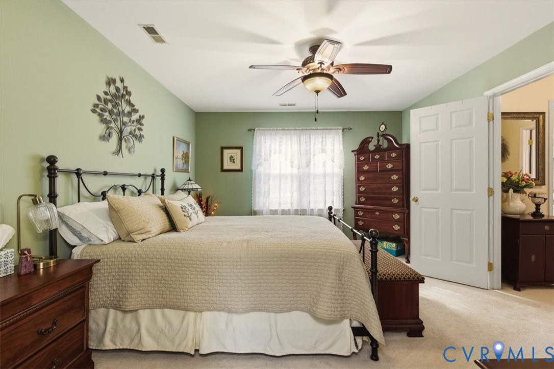 2604 Brookforest Terrace Midlothian, VA 23112 - Photo 27 of 49 a bedroom with a large bed and a chandelier