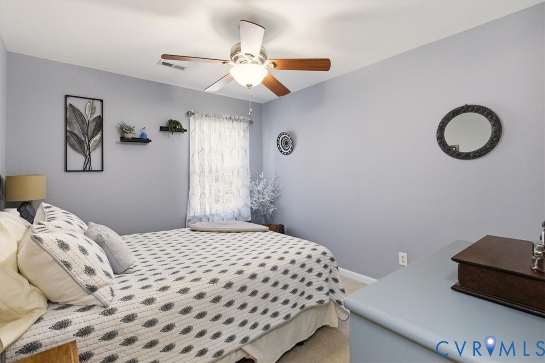 2604 Brookforest Terrace Midlothian, VA 23112 - Photo 34 of 49 a bedroom with a bed and a chandelier