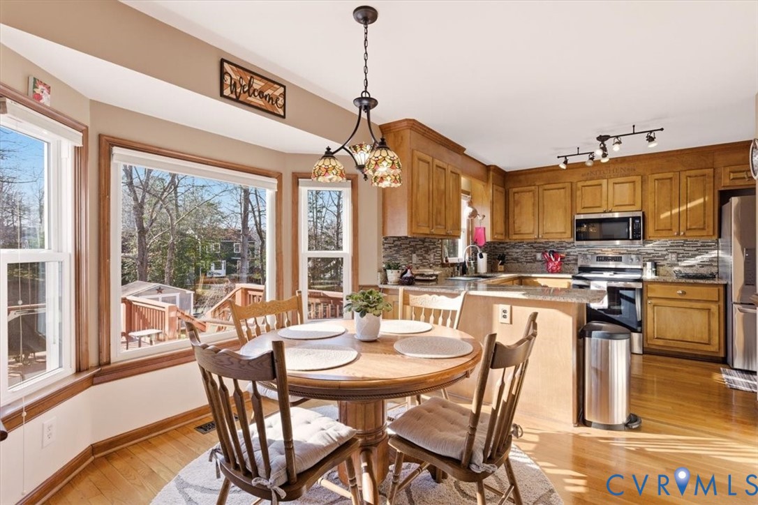 2604 Brookforest Terrace Midlothian, VA 23112 - Photo 10 of 49 a dining room with a table chairs and a kitchen view