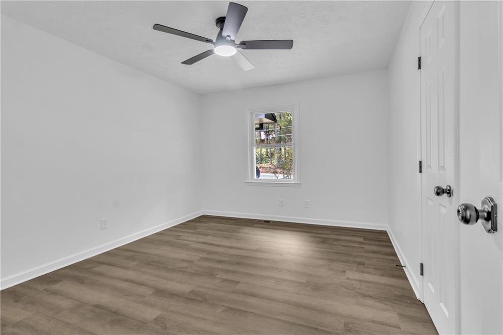 199 McKaskey Creek Road Southeast Cartersville, GA 30121 - Photo 12 of 34 wooden floor in an empty room with a window