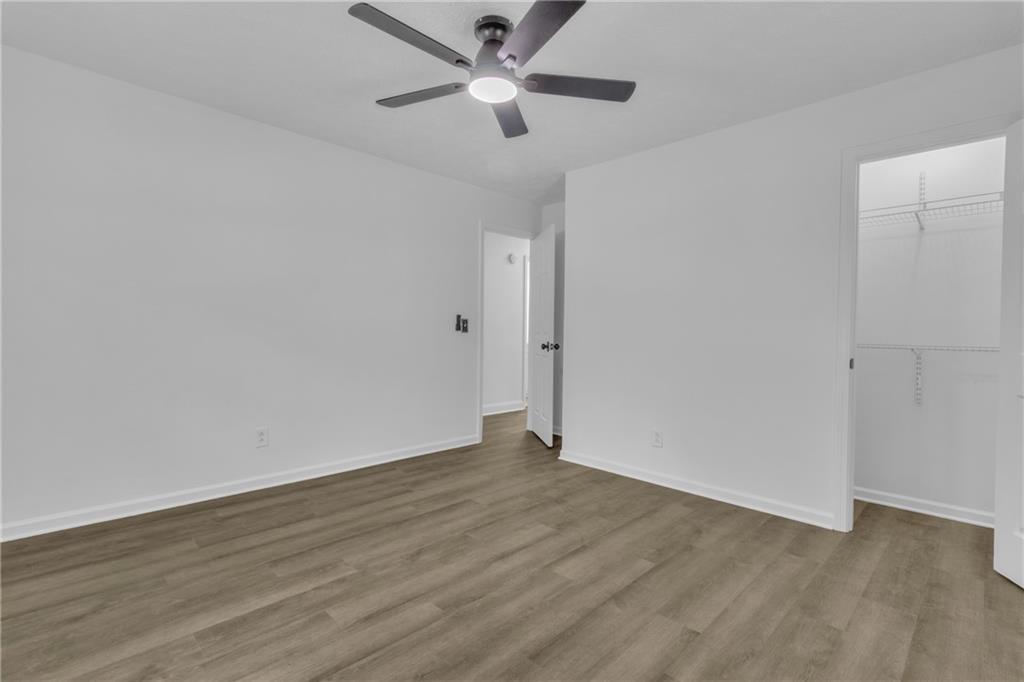 199 McKaskey Creek Road Southeast Cartersville, GA 30121 - Photo 15 of 34 an empty room with wooden floor and a ceiling fan