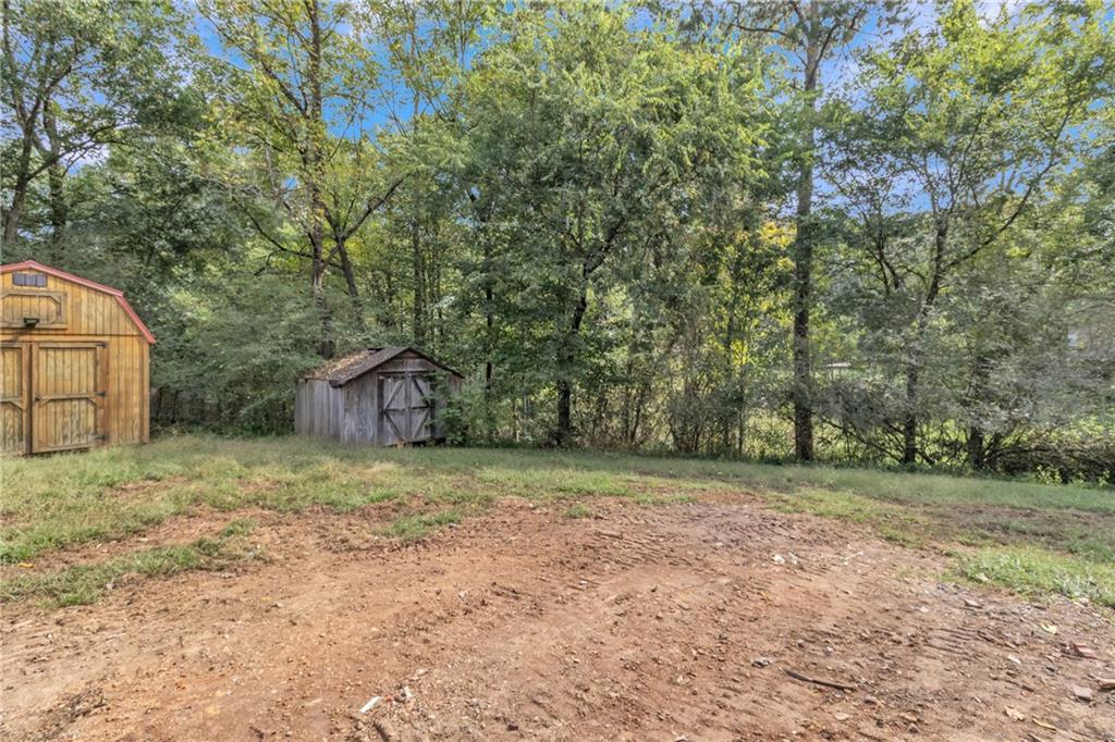199 McKaskey Creek Road Southeast Cartersville, GA 30121 - Photo 27 of 34 a backyard of a house with trees and plants