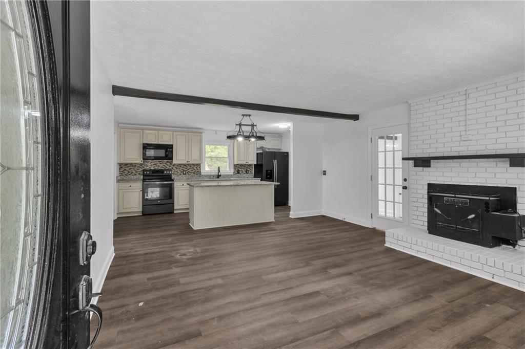 199 McKaskey Creek Road Southeast Cartersville, GA 30121 - Photo 6 of 34 a view of a kitchen with a sink a refrigerator and window