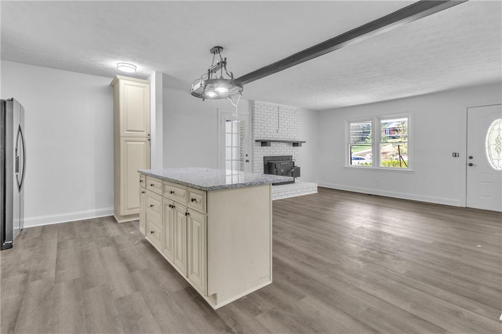 199 McKaskey Creek Road Southeast Cartersville, GA 30121 - Photo 10 of 34 an empty room with wooden floor cabinet and windows