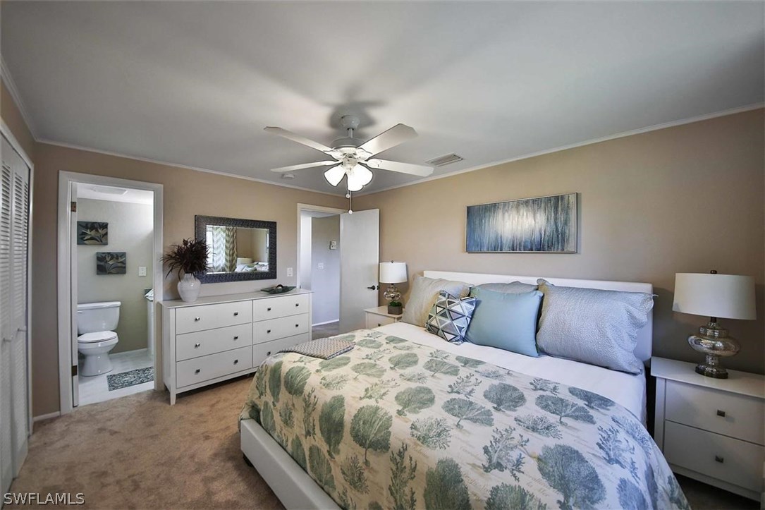 6777 Winkler Road, Unit 203 Fort Myers, FL 33919 - Photo 13 of 25 a bedroom with a large bed and a tv