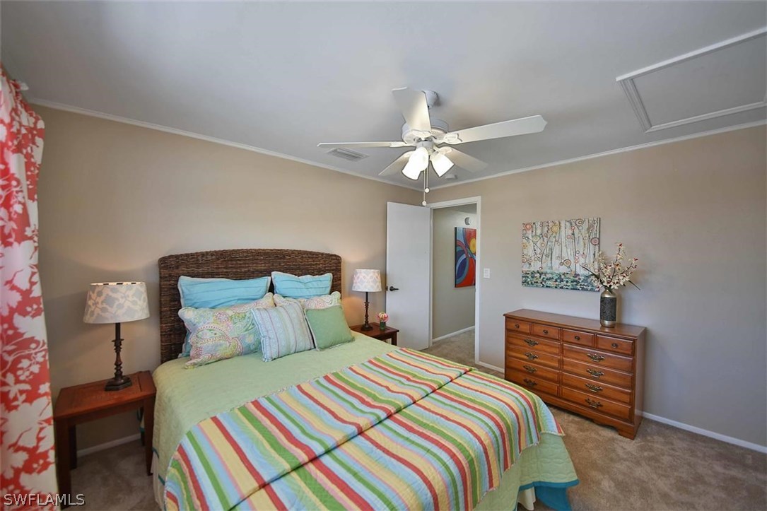 6777 Winkler Road, Unit 203 Fort Myers, FL 33919 - Photo 15 of 25 a bedroom with a bed and a chandelier