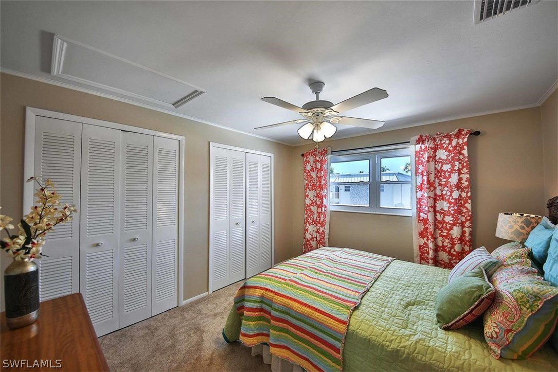 6777 Winkler Road, Unit 203 Fort Myers, FL 33919 - Photo 17 of 25 a bedroom with a large bed and a chandelier