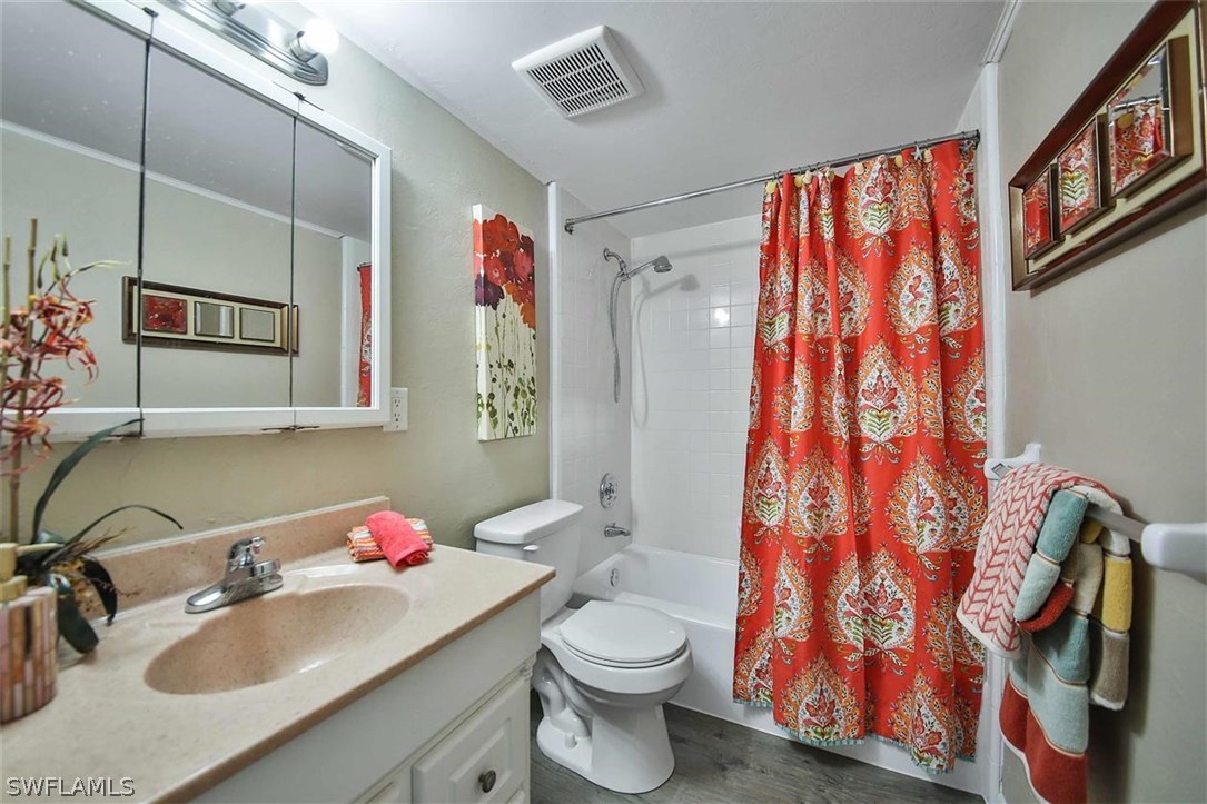 6777 Winkler Road, Unit 203 Fort Myers, FL 33919 - Photo 18 of 25 a bathroom with a sink toilet and shower