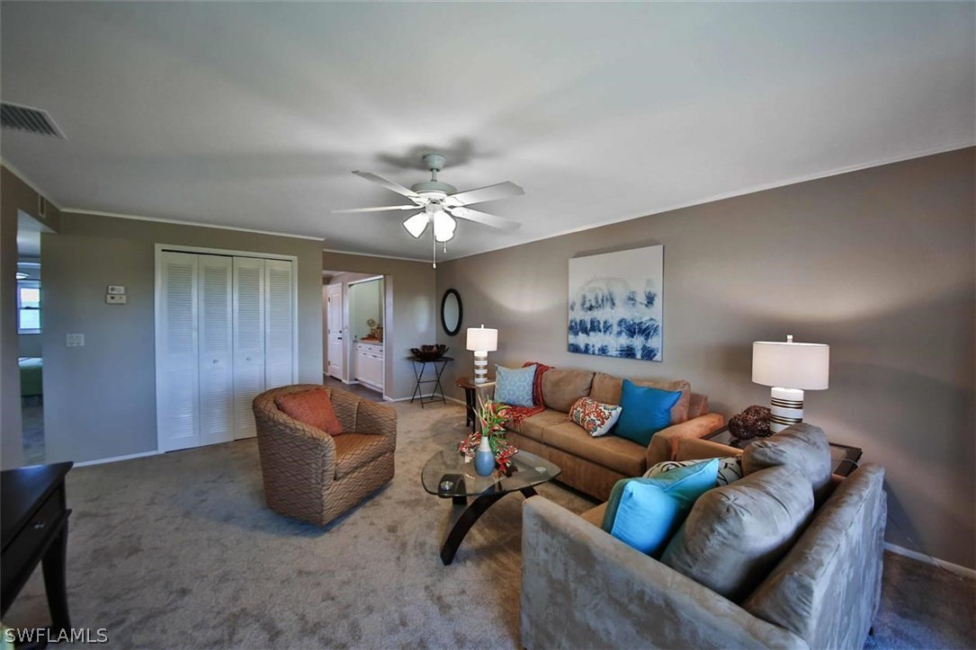 6777 Winkler Road, Unit 203 Fort Myers, FL 33919 - Photo 2 of 25 a living room with furniture and a lamp
