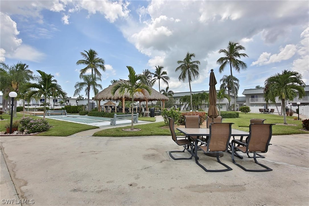 6777 Winkler Road, Unit 203 Fort Myers, FL 33919 - Photo 22 of 25 a view of a yard with furniture and palm tree