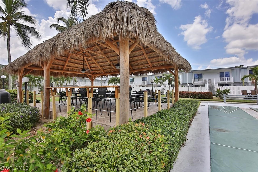 6777 Winkler Road, Unit 203 Fort Myers, FL 33919 - Photo 24 of 25 a view of a patio with a table and chairs