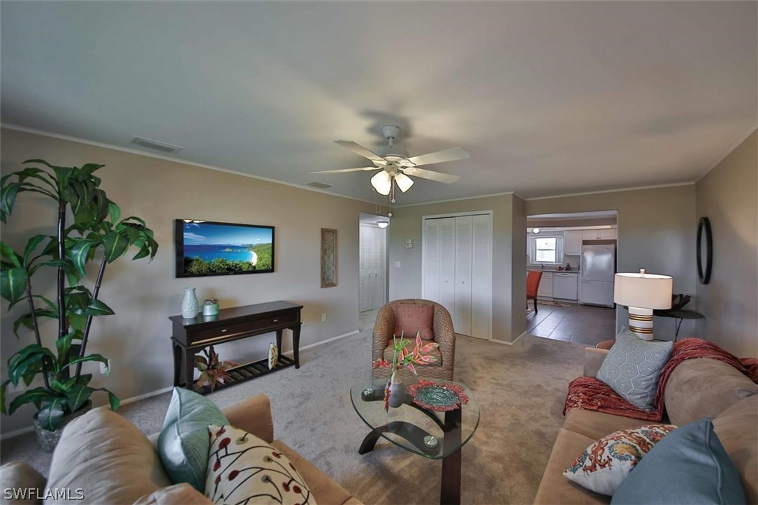 6777 Winkler Road, Unit 203 Fort Myers, FL 33919 - Photo 4 of 25 a living room with furniture and a chandelier