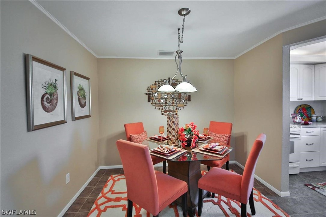 6777 Winkler Road, Unit 203 Fort Myers, FL 33919 - Photo 5 of 25 a dining room with furniture and chandelier