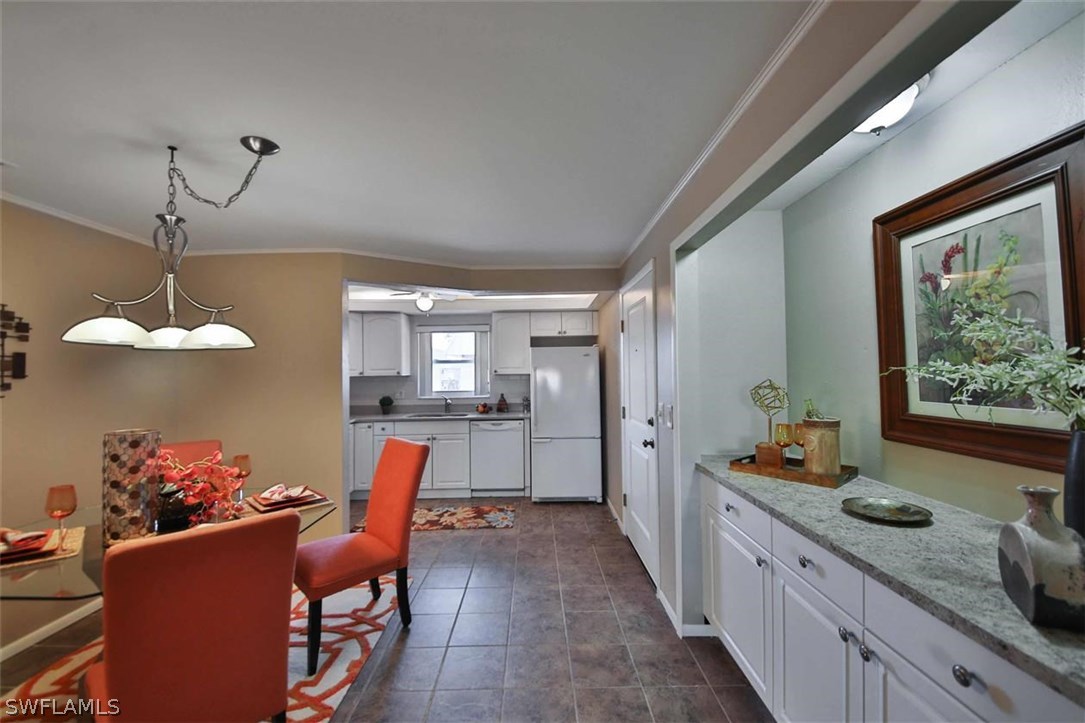 6777 Winkler Road, Unit 203 Fort Myers, FL 33919 - Photo 7 of 25 a dining hall with stainless steel appliances kitchen island granite countertop furniture and a kitchen view