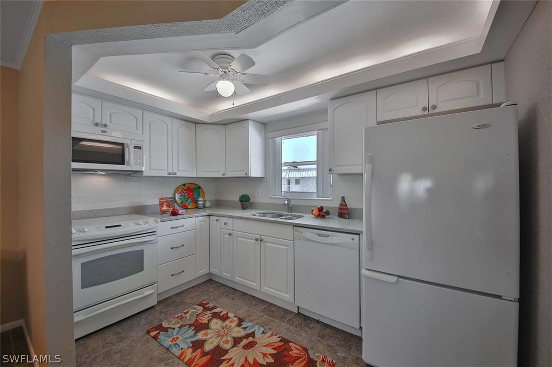 6777 Winkler Road, Unit 203 Fort Myers, FL 33919 - Photo 9 of 25 a kitchen with cabinets and stainless steel appliances