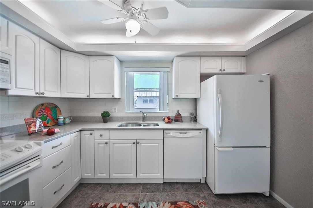 6777 Winkler Road, Unit 203 Fort Myers, FL 33919 - Photo 10 of 25 a white refrigerator freezer sitting inside of a kitchen