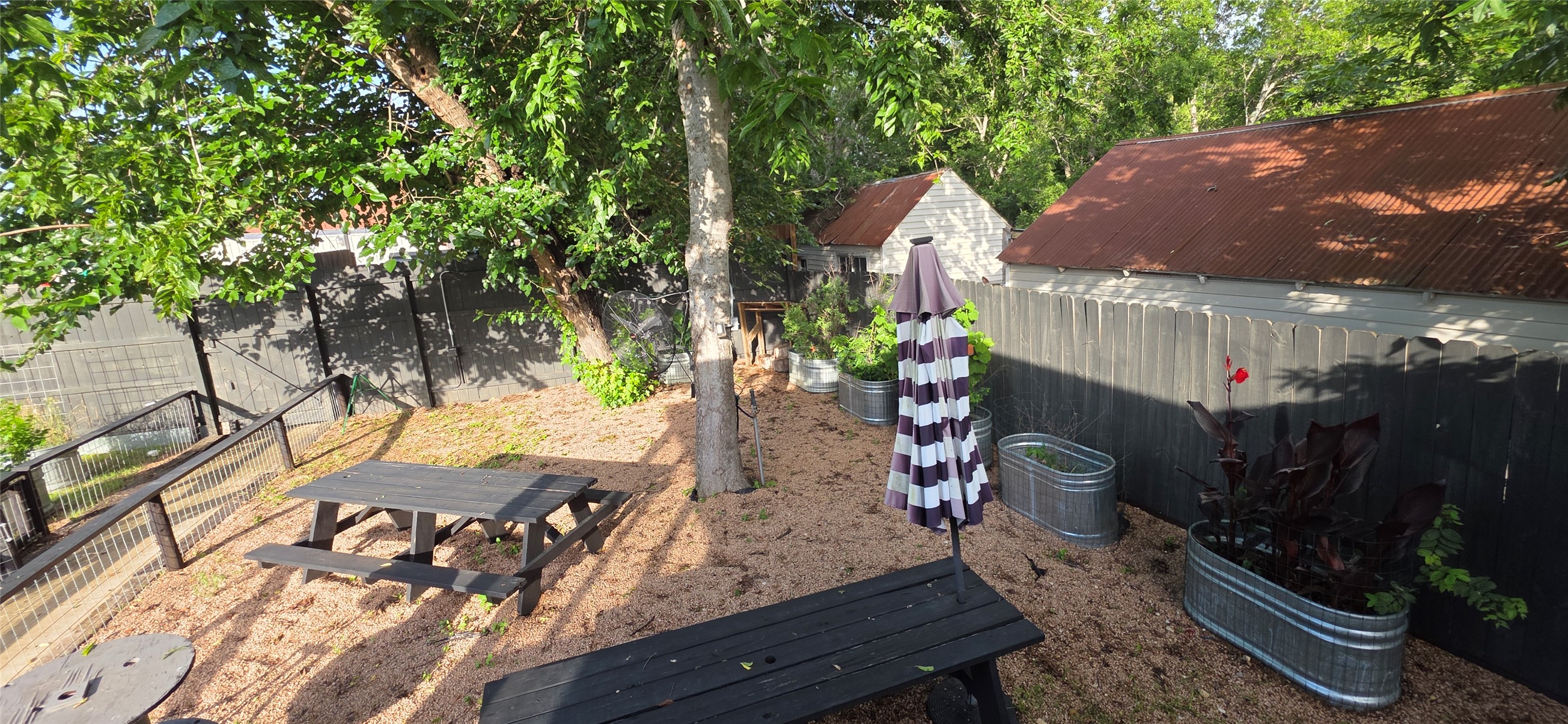 916 South Main Street Lockhart, TX 78644 - Photo 7 of 18 A private, shaded backyard retreat offers ample space for entertaining and relaxation.