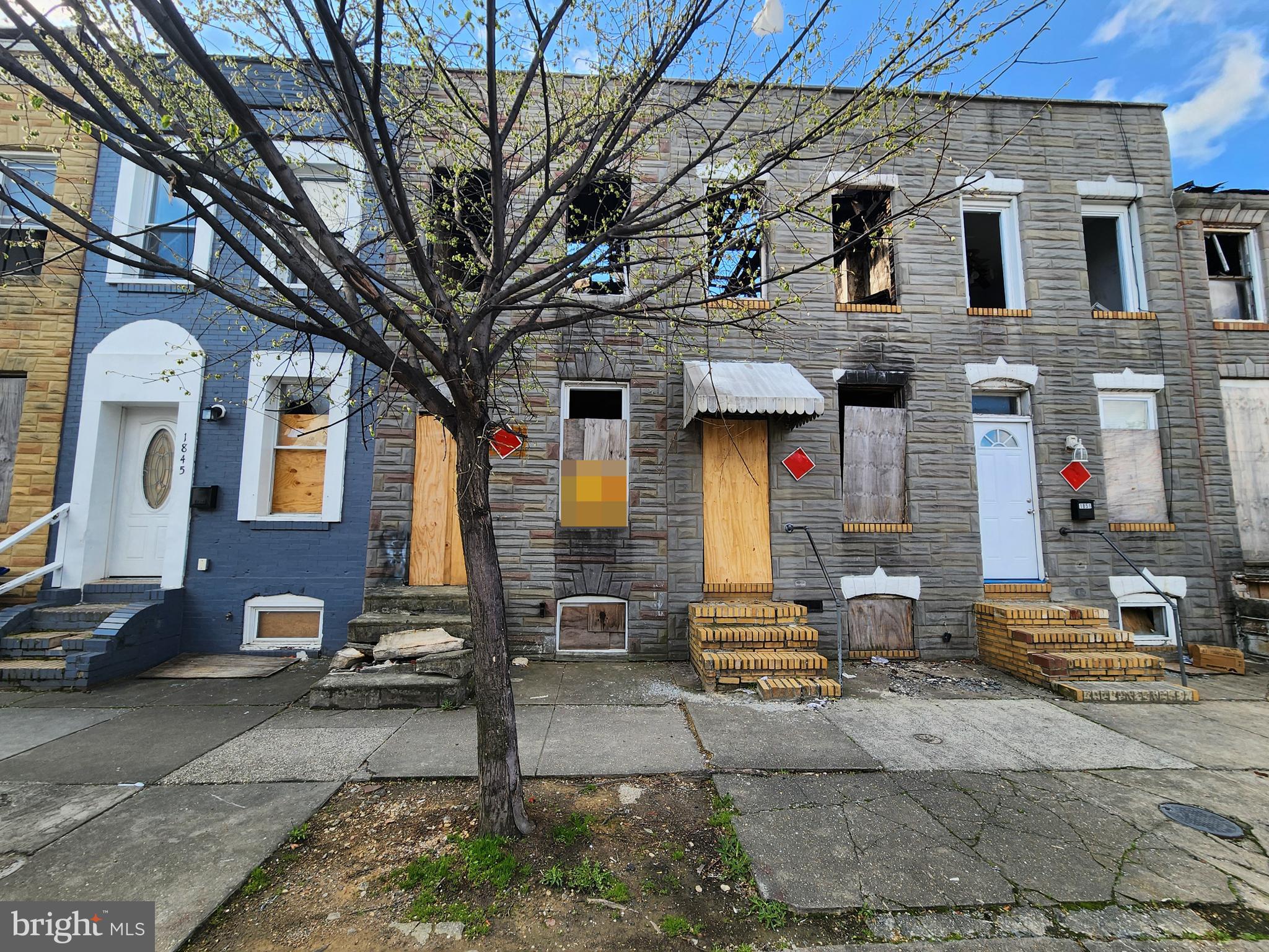 1847 Ramsay Street Baltimore, MD 21223 - Photo 2 of 5 a front view of a building with large trees