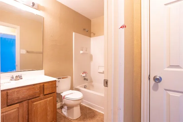 a bathroom with a toilet a sink and a mirror