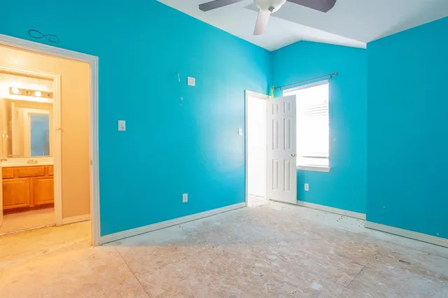 an empty room with closet and windows