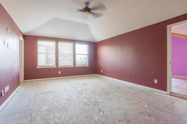 an empty room with windows and closet