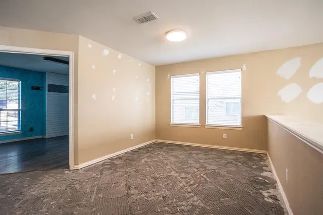 an empty room with windows and entrance