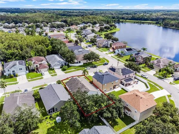 an aerial view of a houses with a yard