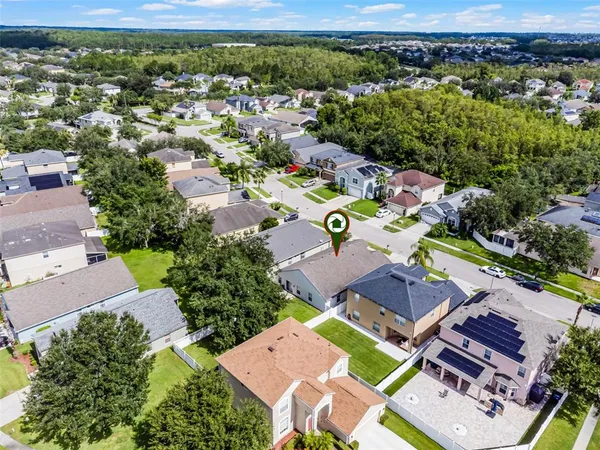 an aerial view of a house with a yard swimming pool