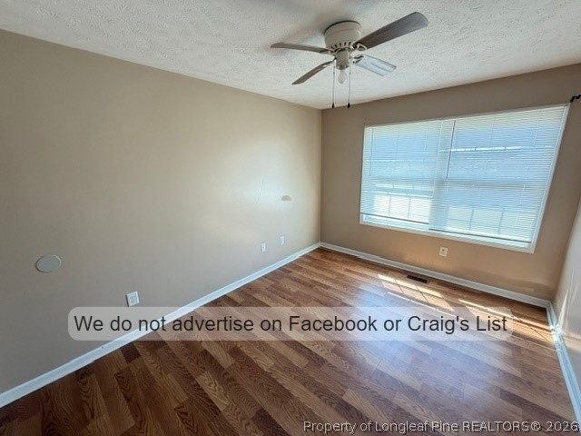 6467 Yadkin Road, Unit 1 Fayetteville, NC 28303 - Photo 6 of 9 a view of a bedroom with wooden floor and fan