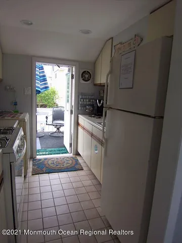 a kitchen with a refrigerator and a stove