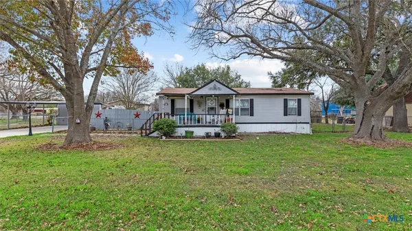 a front view of a house with yard and green space