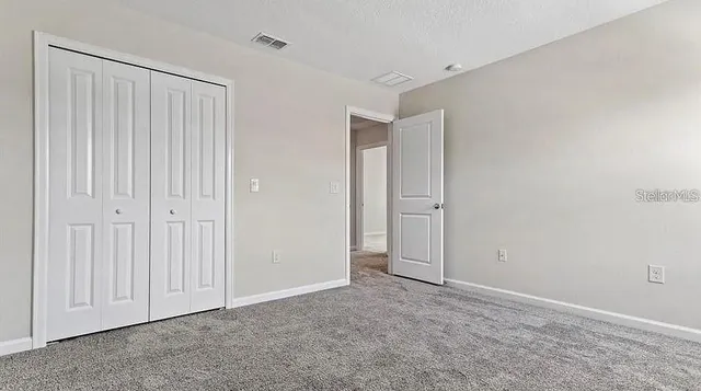 an empty room with closet area