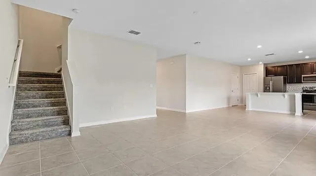 a view of kitchen and refrigerator