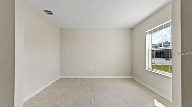 a view of an empty room with a window