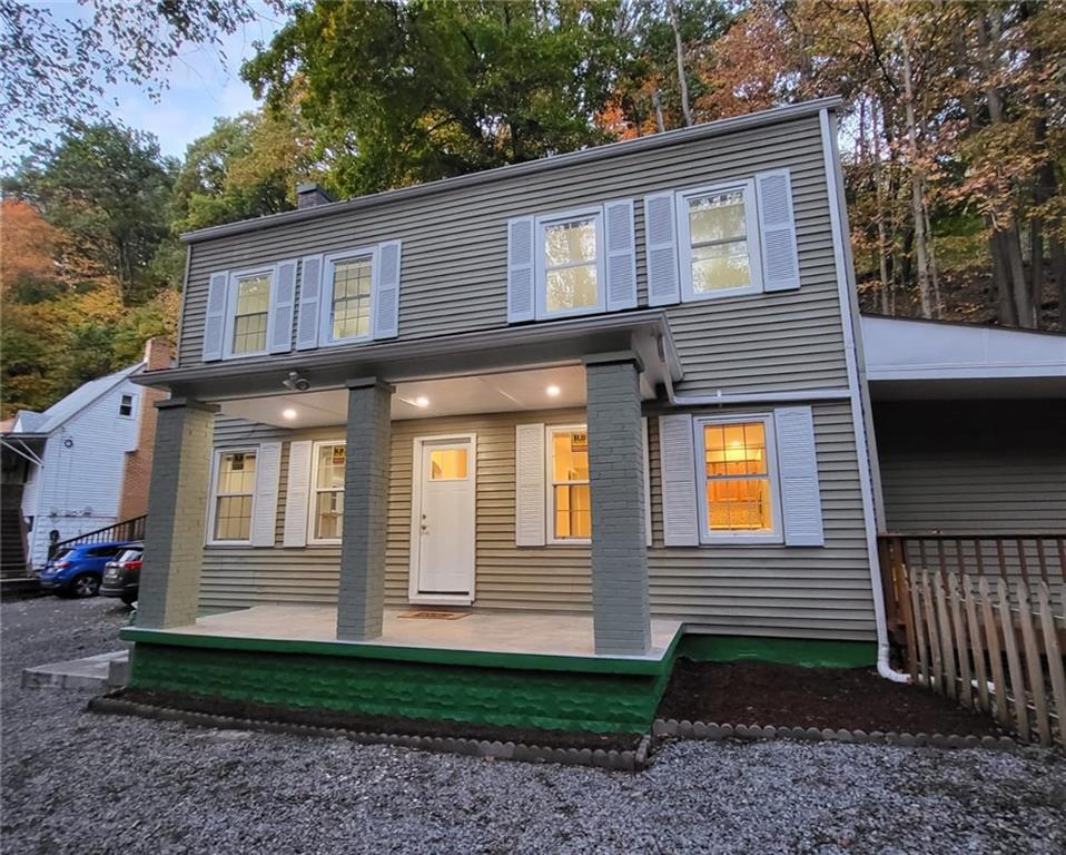 a view of a house with a yard and large windows