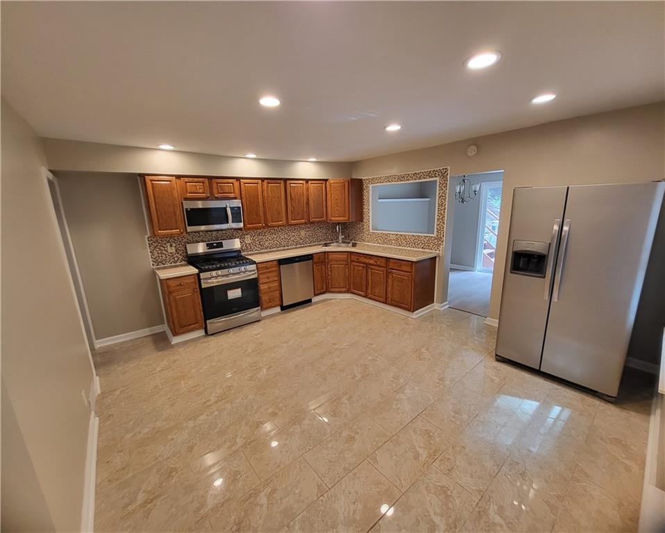 279 Nelson Run Road Pittsburgh, PA 15237 - Photo 9 of 38 a kitchen with stainless steel appliances a refrigerator and a stove top oven