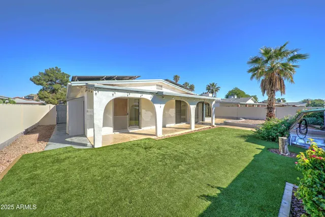 a view of a house with a yard and a garden