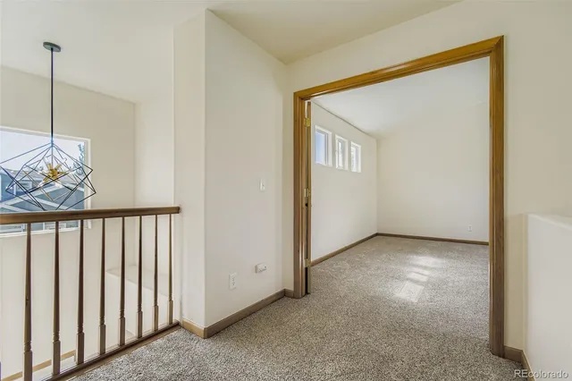 a view of a hallway to rooms