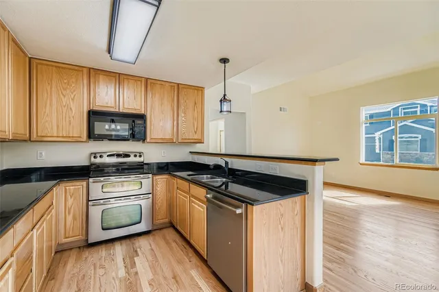 a kitchen with a stove a sink and a microwave