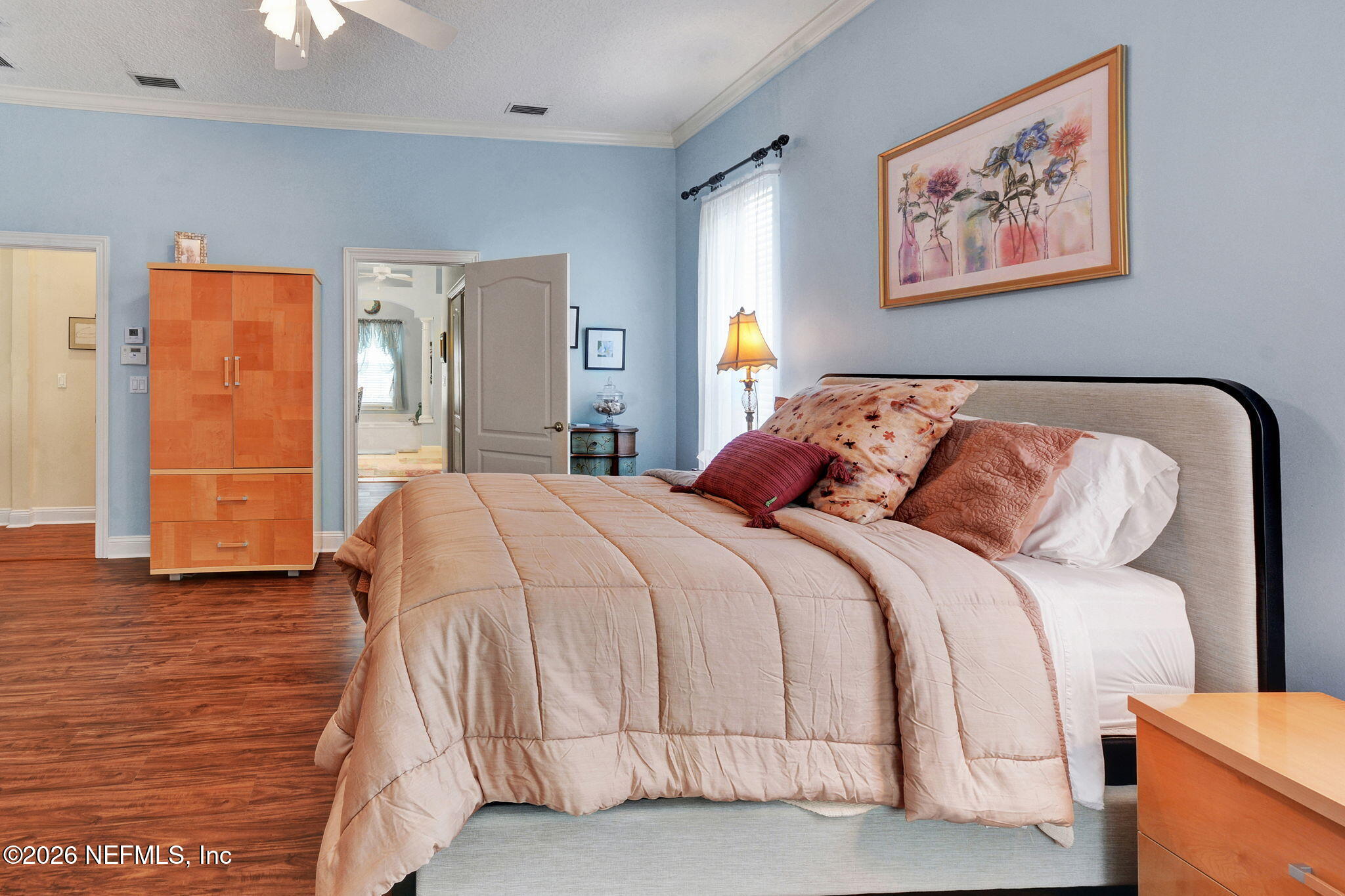 5950 West Shores Road Orange Park, FL 32003 - Photo 22 of 42 a bedroom with a bed and painting on the wall