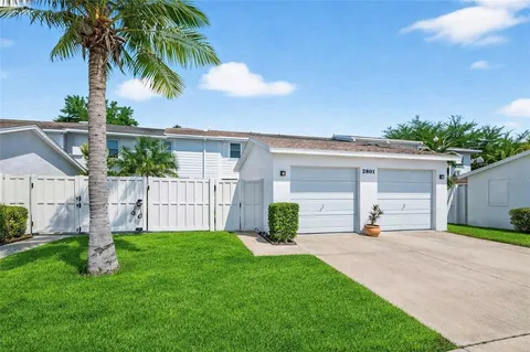 a front view of house with yard and trees