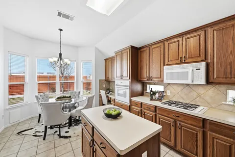 a kitchen with sink cabinets and stove top oven